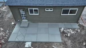small poured concrete patio with decorative control joints