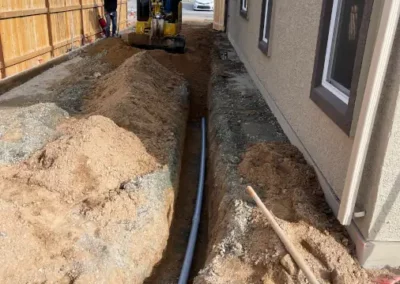 Mini excavator trenching in a tight side-yard