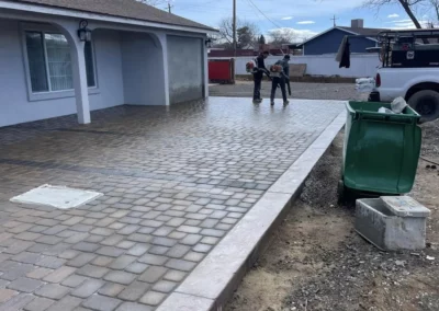 Grand front entryway with brick pavers and stamped concrete border