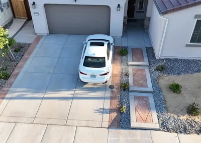 concrete driveway with stamped side aprons and custom floating stamped concrete walk