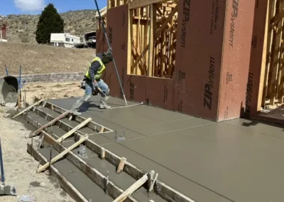 Newly poured monolithic poured concrete entry landing and stairs for a new custom home.